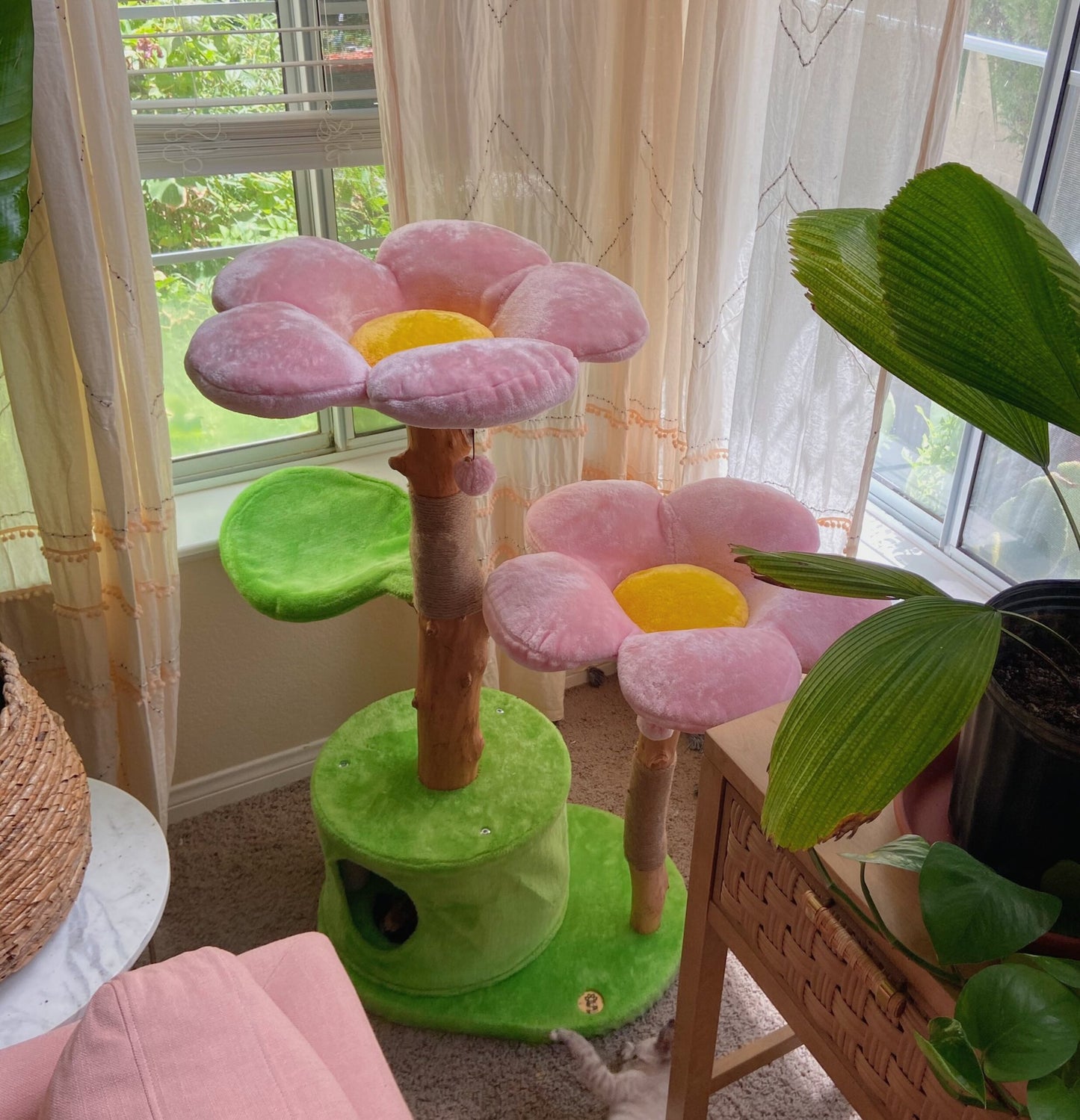 Floral cat tree with pink flowers and a plant, creating a cozy space for cats with a floral aesthetic